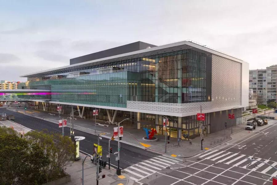 A wide shot of the glassy, modern Moscone Center South building.